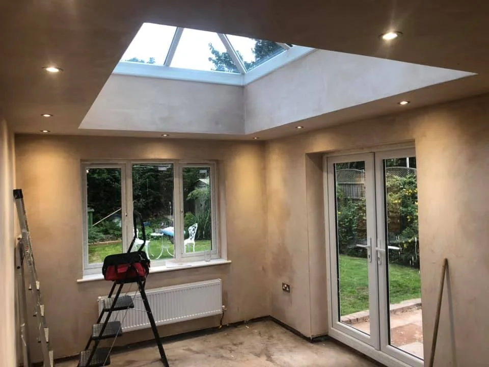 Recessed ceiling lights in an extension with rooflights and garden doors